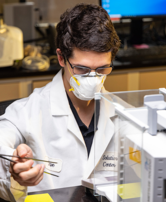 Andrew conducting a specific gravity test on PVC specimen