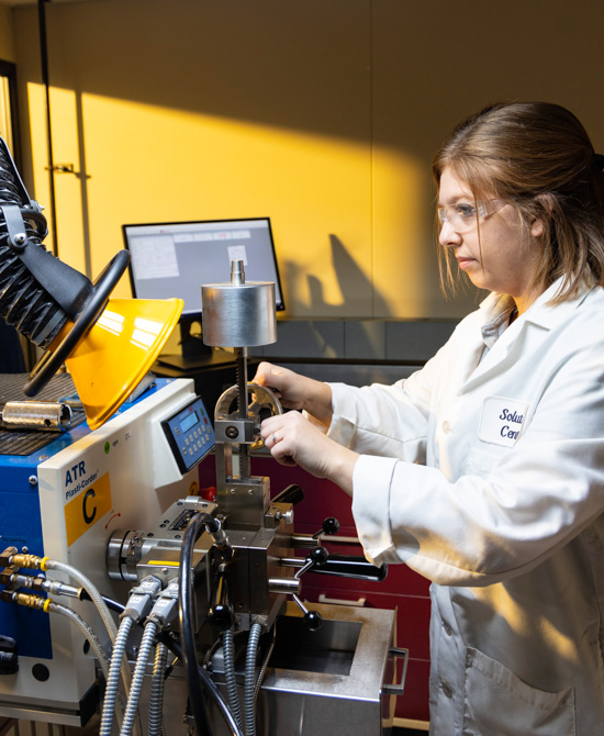 employee wearing lab coat conducting tests
