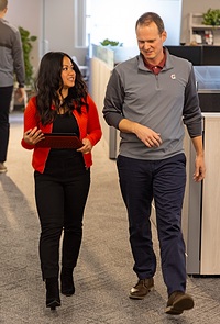 two people walking in hallway