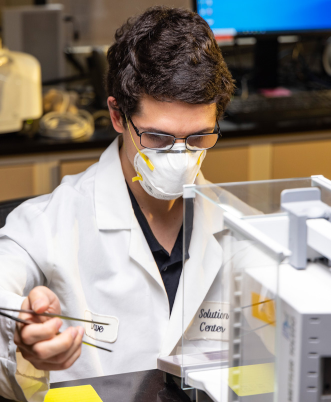 Andrew conducting a specific gravity test on PVC specimen