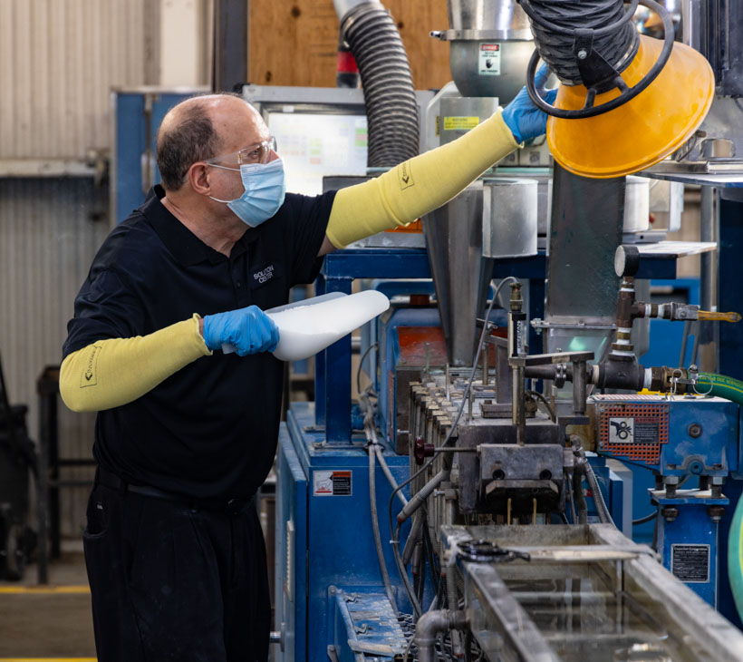 person scooping pellets into machine