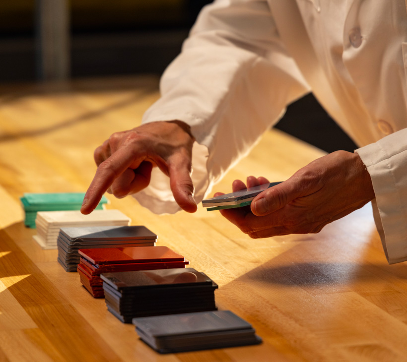 a person's hands selecting multicolored cards